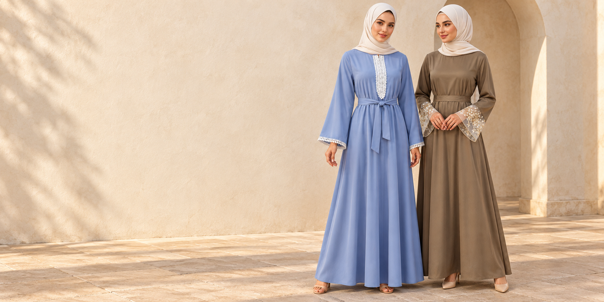 FUMIDAR blue lace-trim dress and taupe embroidered-cuff dress in a warm limestone courtyard